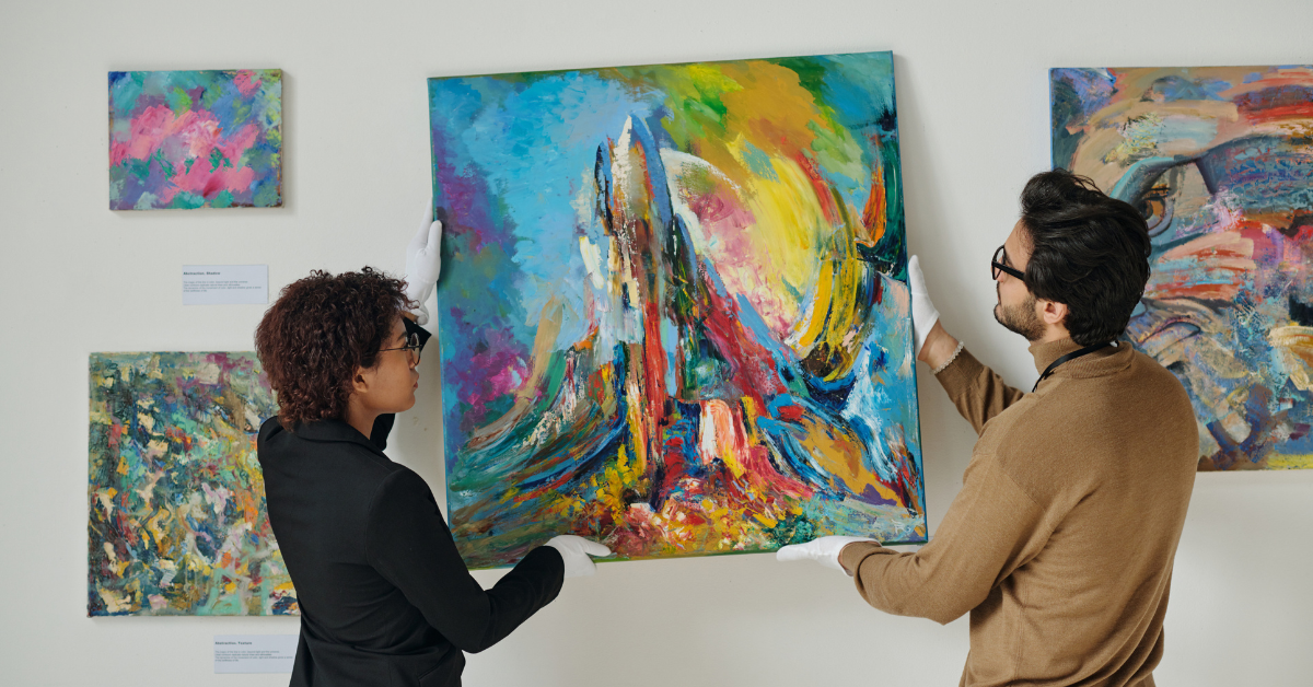 Gallery curators hanging art-1